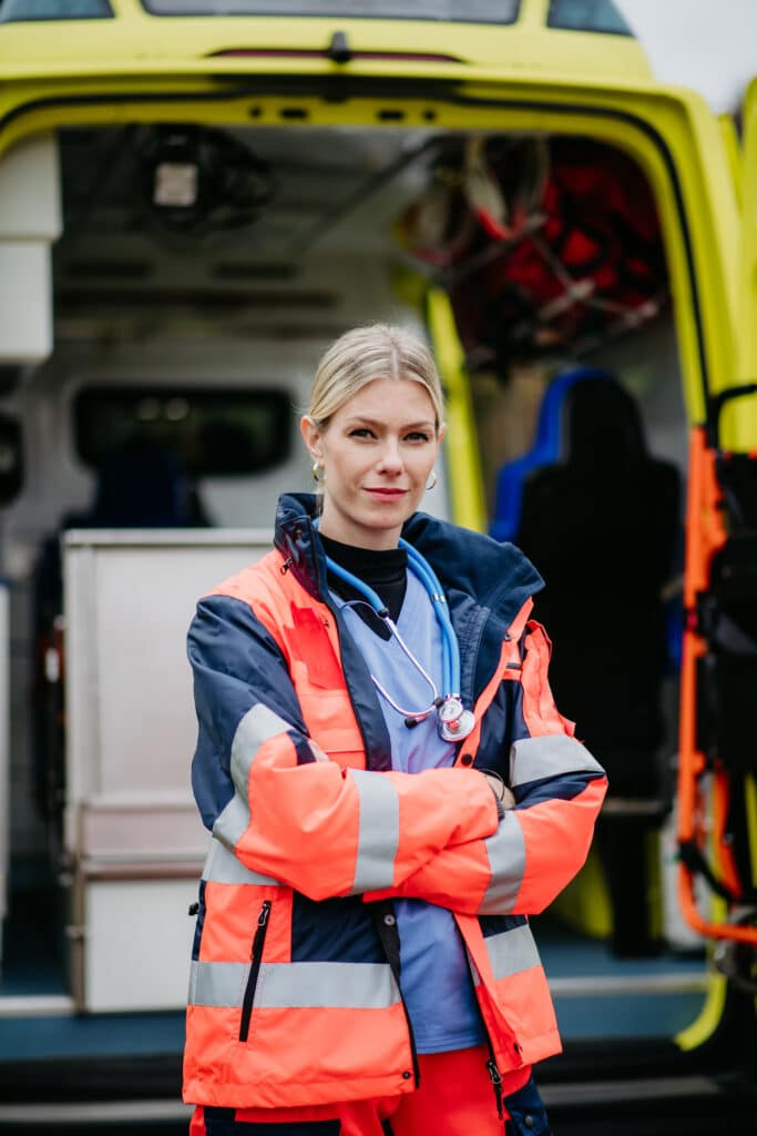 Woman doctor standing in front of ambulance